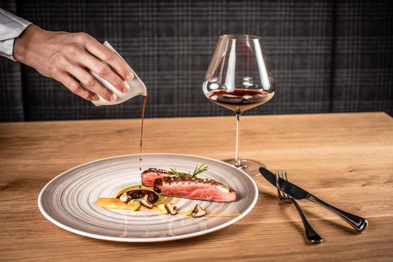 Hotel My Arbor - Dolomites Bresanona Exterior foto A server pouring sauce onto a prepared dish